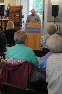 Curator, Dr. T. W. Acheson, speaking at the From Black Bag to High Science exhibit opening at the Fredericton Region Museum.