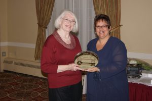 Lyne Bard (left) presenting the Quarter Century Volunteer Award to Elizabeth Earl at the Association Museums New Brunswick awards banquet in Moncton on October 14th.