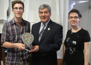 Ian Malcolm (summer student), His Honour Graydon Nicholas and Samira Torabi (volunteer) with the beaded cap (1969.371.1).